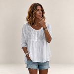 Valvet Oak House white blouse with floral embroidery and patchwork detail worn by a woman with denim shorts