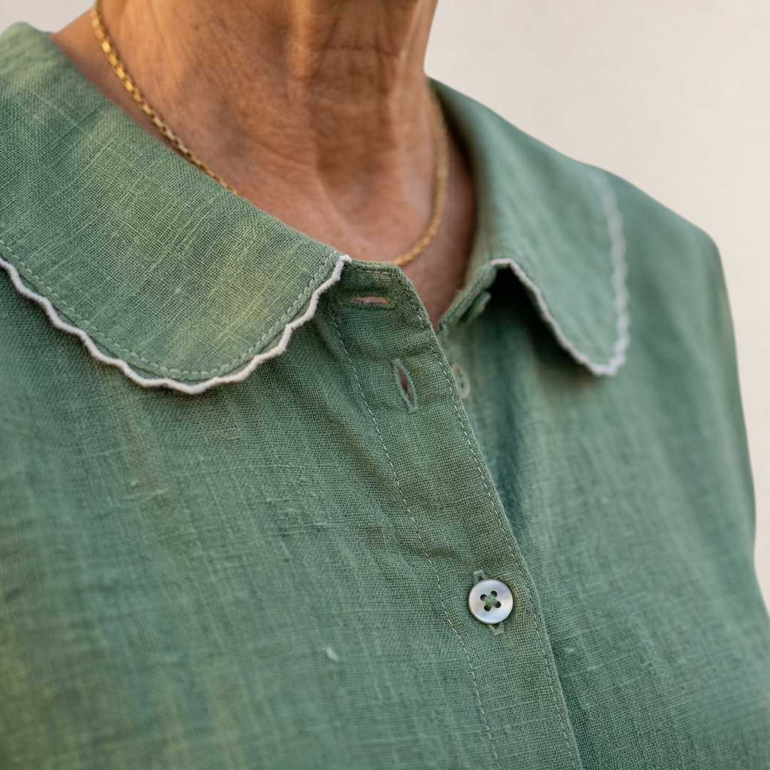 Valvet Oak House sage green cotton blouse featuring a scalloped collar with white trim and button-up front.