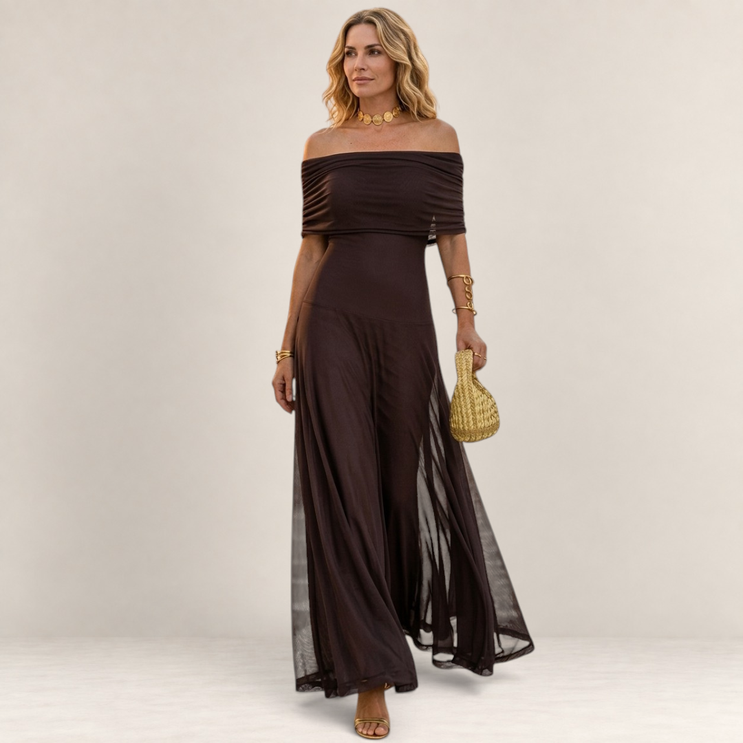Valvet Oak House Chloe off-the-shoulder dark brown maxi dress worn by a blonde model with gold jewelry