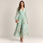 Valvet Oak House midi dress in mint green chiffon with floral print, pleated skirt, and long sleeves on a model.
