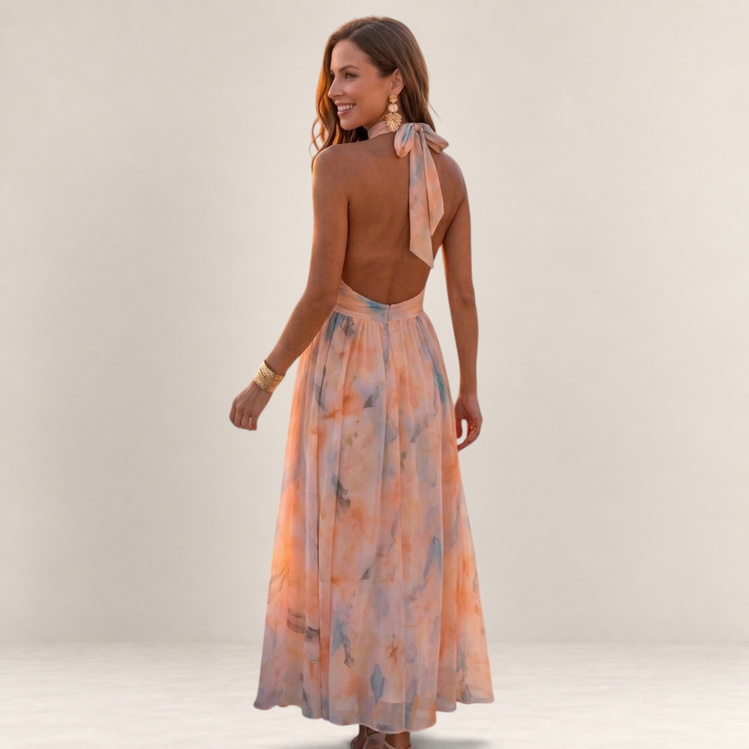 Valvet Oak House Stephanie silk maxi dress with halter neckline and floral watercolor print on a smiling model