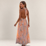 Valvet Oak House Stephanie silk maxi dress with halter neckline and floral watercolor print on a smiling model