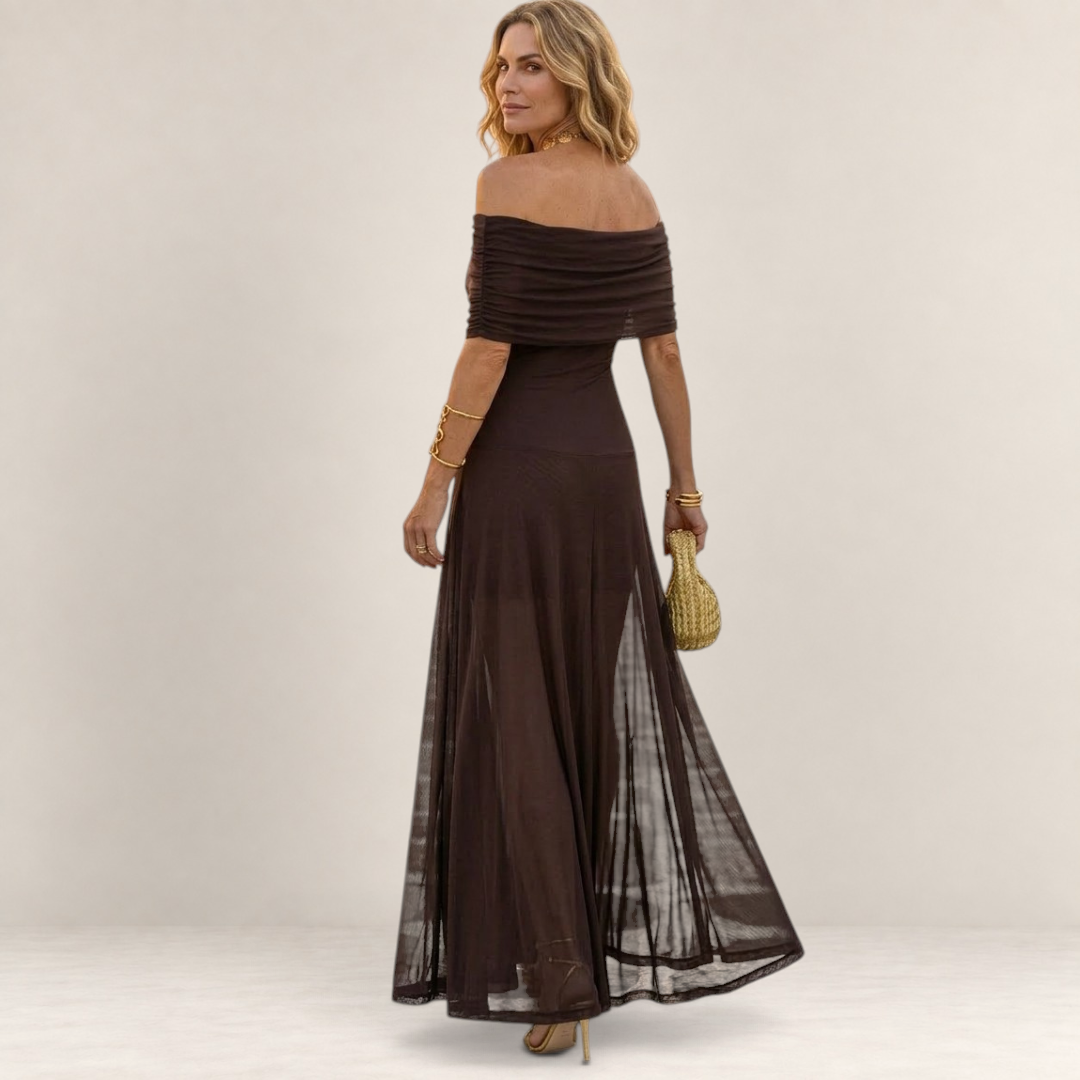 Valvet Oak House Chloe brown off-the-shoulder maxi dress with a sheer flowing skirt worn by a woman