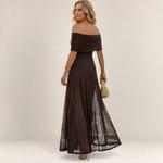 Valvet Oak House Chloe brown off-the-shoulder maxi dress with a sheer flowing skirt worn by a woman