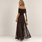 Valvet Oak House Chloe brown off-the-shoulder maxi dress with a sheer flowing skirt worn by a woman