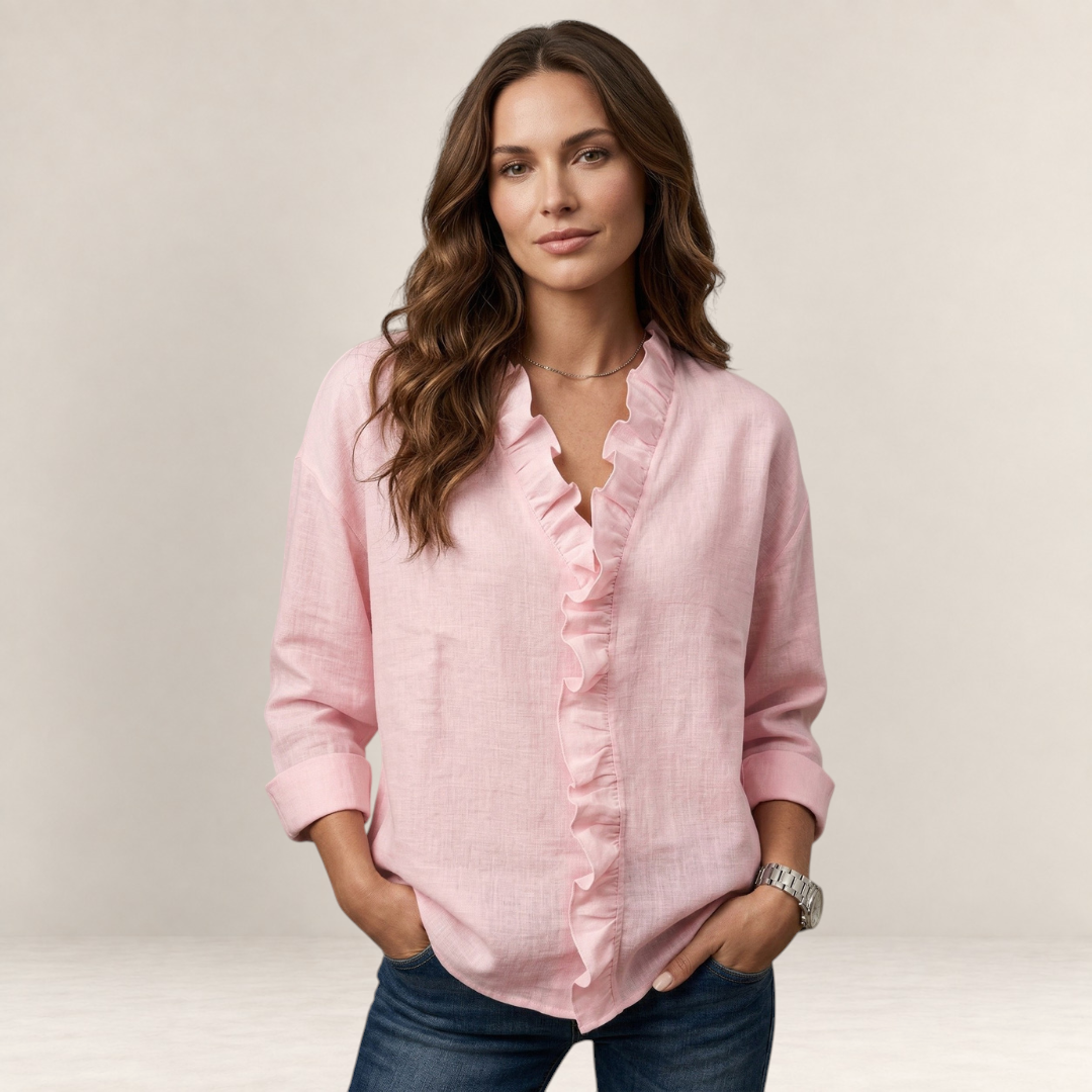 Valvet Oak House Elaine light pink linen blouse with ruffled V-neck worn by a woman with long wavy brown hair