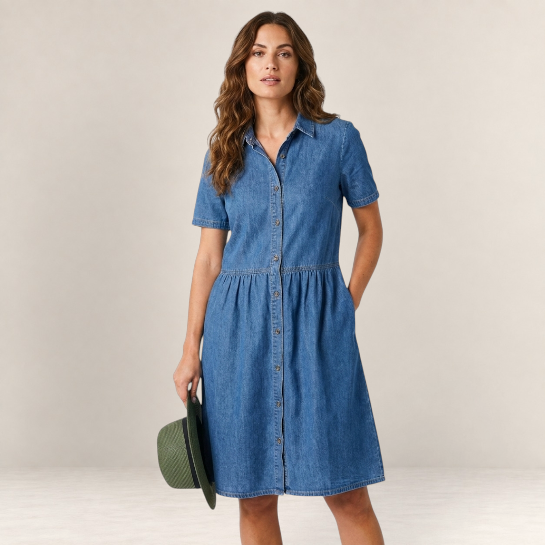 Valvet Oak House Neusa denim dress with button-down front and short sleeves worn by a model holding a green hat