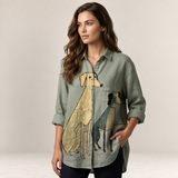 Valvet Oak House Hera sage green linen button-down shirt with whimsical dog print worn by a woman