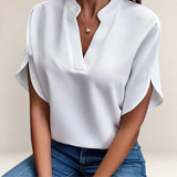 Valvet Oak House Agatha white blouse featuring a structured collar and short sleeves, styled with blue jeans.