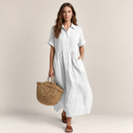 Valvet Oak House white cotton shirt dress with button-down front and pleated bodice worn by a woman with a straw bag