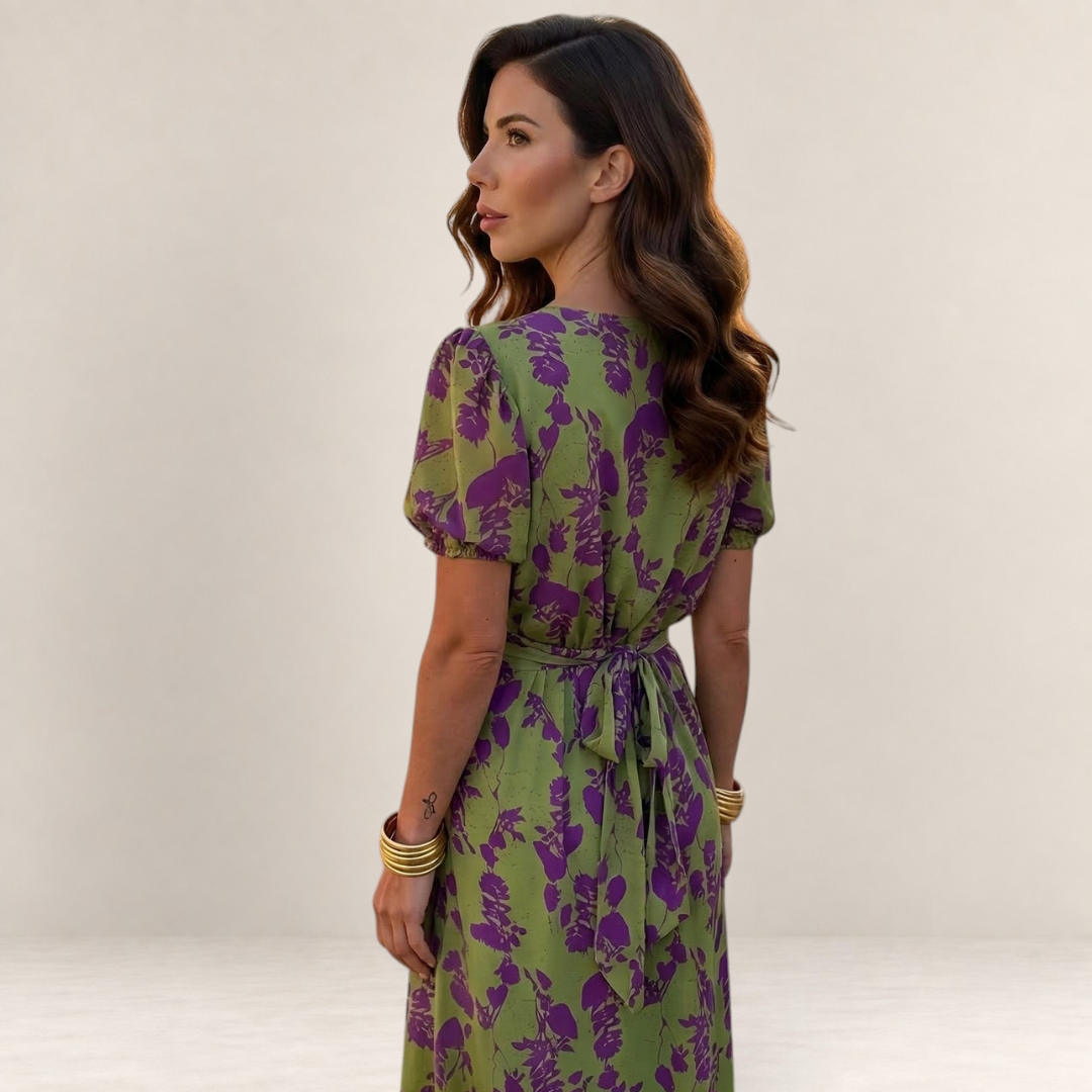 Valvet Oak House Lara floral midi dress in green and purple with puff sleeves and a tie-back waist on a model.