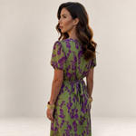 Valvet Oak House Lara floral midi dress in green and purple with puff sleeves and a tie-back waist on a model.
