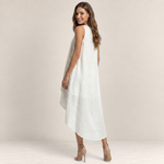 Valvet Oak House white linen midi dress with sleeveless design and high-low asymmetrical hem on a smiling model