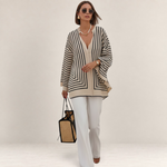 Valvet Oak House Thetis striped blouse with a flowing silhouette, V-neck, and long sleeves in beige and black.