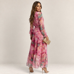 Valvet Oak House Luzia floral print maxi dress with long sleeves and tiered skirt worn by a model from behind