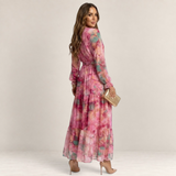 Valvet Oak House Luzia floral print maxi dress with long sleeves and tiered skirt worn by a model from behind
