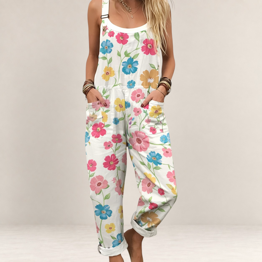 Valvet Oak House Nikoletta floral print jumpsuit with wide legs, adjustable straps, and side pockets on a model.