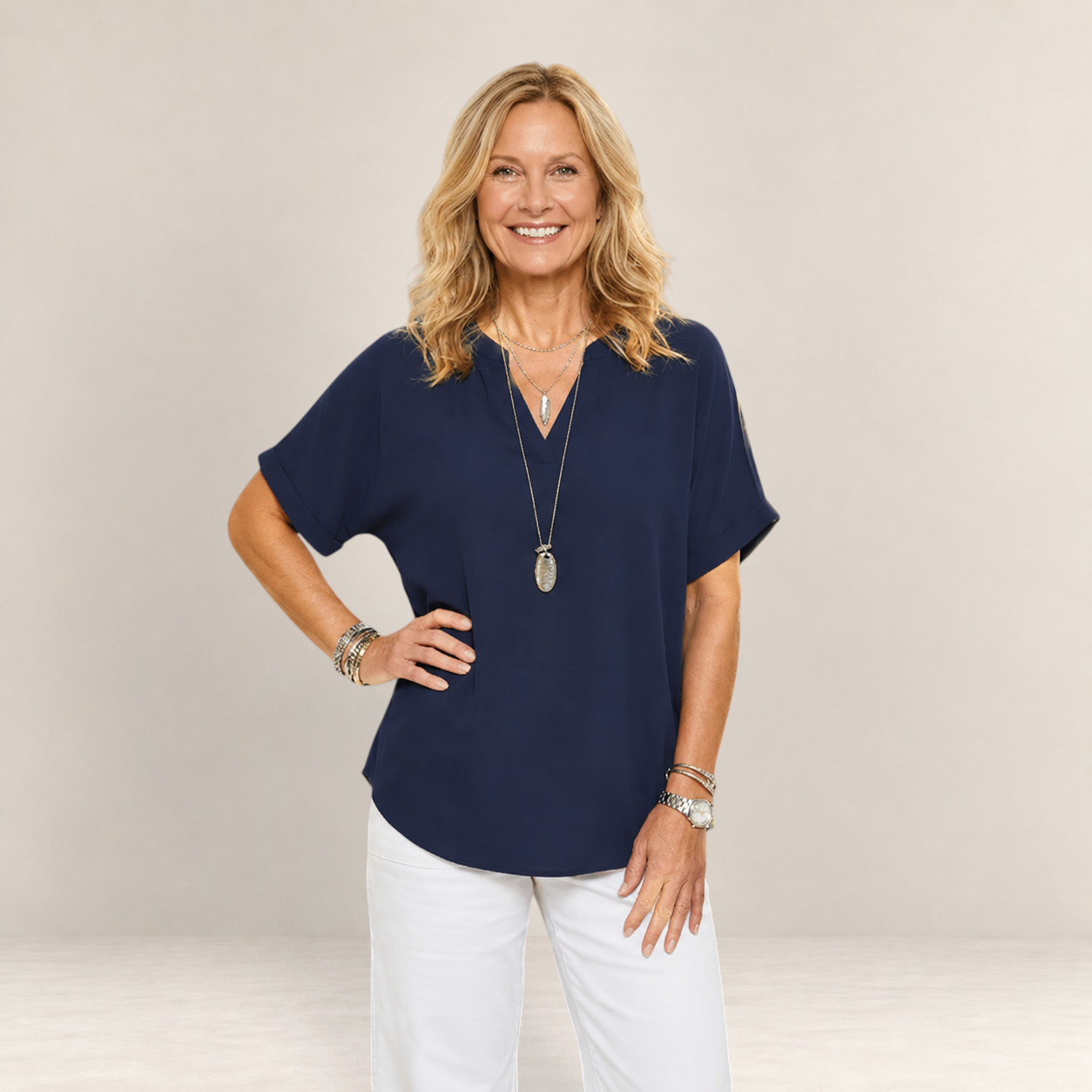 Valvet Oak House navy blue lightweight V-neck top worn by a smiling woman with blonde hair and layered necklaces.