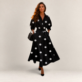 Valvet Oak House Lana black cotton midi dress with white polka dots, collar, and long sleeves worn by a model.