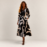 Valvet Oak House Lana cotton midi dress with a black and white abstract print, collar, and long sleeves on a model.