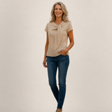 Valvet Oak House Hera beige linen short-sleeve blouse with neck detail worn by a woman with blue jeans