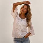Valvet Oak House white cotton blouse with butterfly sleeves and floral embroidery worn by a woman in Prague