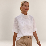 Valvet Oak House Calíope white blouse with floral relief embroidery, high neck, and short sleeves on a model