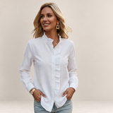 Valvet Oak House white long-sleeve blouse with a ruffled collar and button-down front worn by a blonde woman