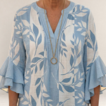 Valvet Oak House Agapi blouse in light blue and white with leaf print, V-neck, and tiered ruffled sleeves.