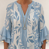 Valvet Oak House Agapi blouse in light blue and white with leaf print, V-neck, and tiered ruffled sleeves.