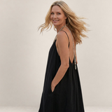 Valvet Oak House Safira black summer dress with thin straps and A-line silhouette worn by a smiling blonde woman