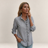 Valvet Oak House striped button-down shirt with ruffled front detail worn by a woman with gold jewelry