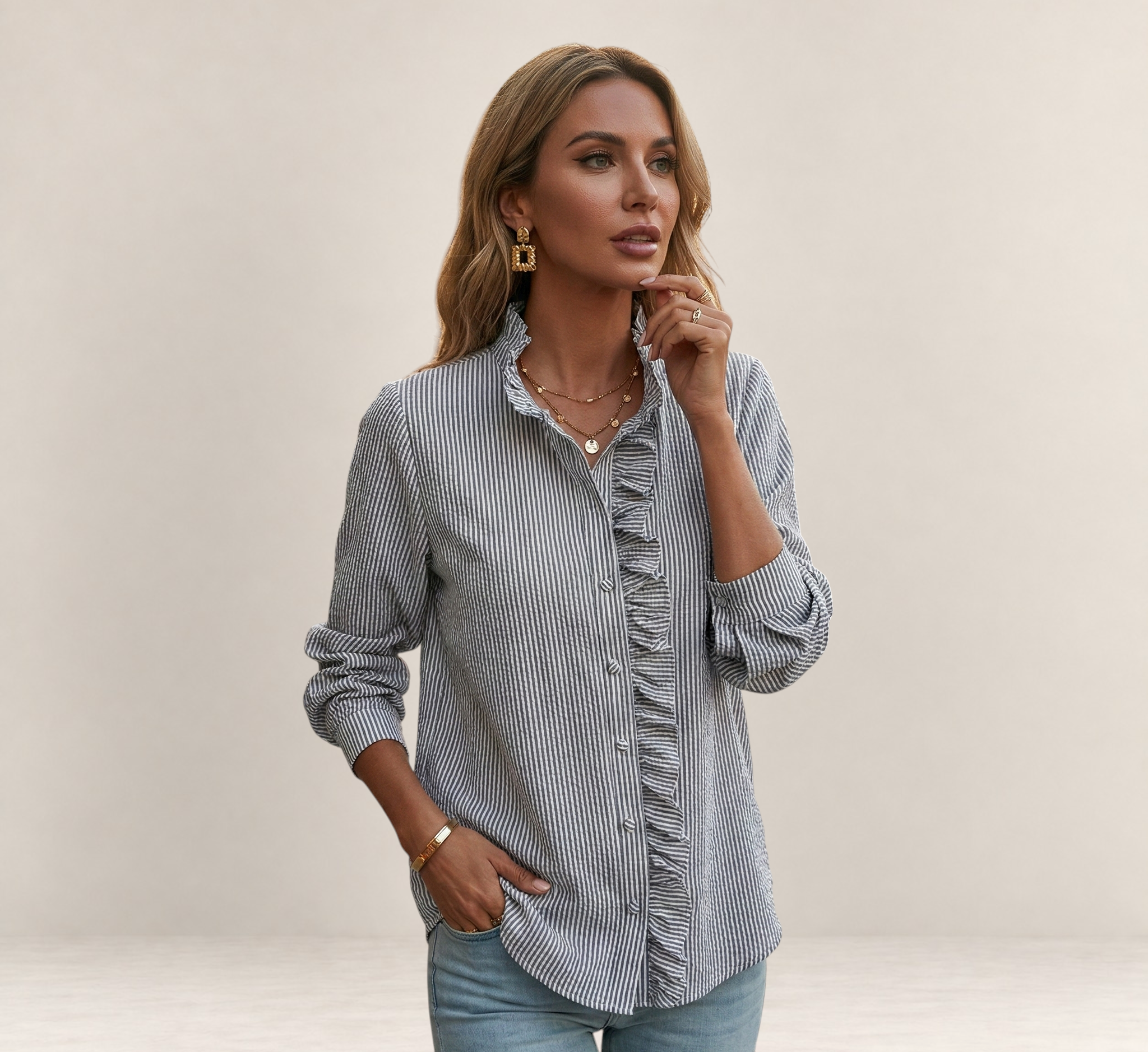 Valvet Oak House striped button-down shirt with ruffled front detail worn by a woman with gold jewelry