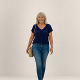 Valvet Oak House Despina navy blue blouse with a flattering flowy fit worn by a smiling woman with jeans and bag