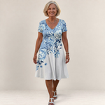 Valvet Oak House Leda floral print dress with V-neck and short sleeves worn by a smiling woman