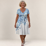 Valvet Oak House Leda floral print dress with V-neck and short sleeves worn by a smiling woman
