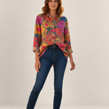 Valvet Oak House Anastasia shirt in vibrant floral print Tencel fabric worn by a model with dark blue jeans