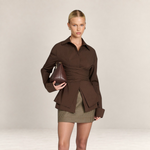 Valvet Oak House brown wrap-style blouse with oversized cuffs and V-neck, worn by a model with a matching handbag.
