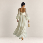 Valvet Oak House romantic cream maxi dress with long puff sleeves and a flowing skirt, back view