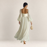 Valvet Oak House romantic cream maxi dress with long puff sleeves and a flowing skirt, back view