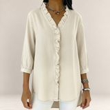 Valvet Oak House Elena beige blouse with delicate ruffles, V-neck, and three-quarter sleeves on a model