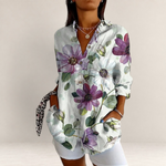 Valvet Oak House long-sleeve button-up blouse featuring a white base with vibrant purple and green floral patterns.