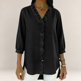 Valvet Oak House black denim blouse featuring a V-neckline with delicate ruffles and three-quarter length sleeves.