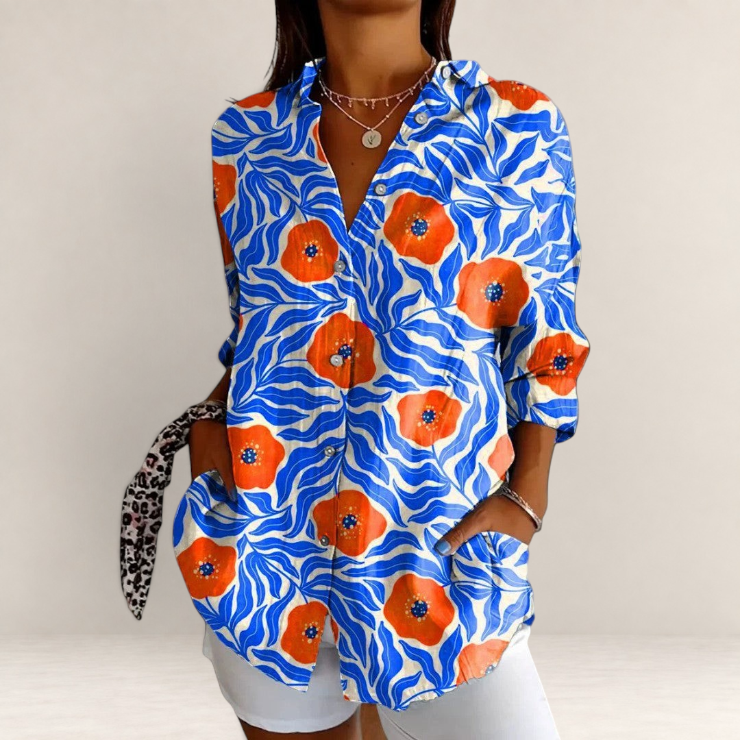 Valvet Oak House long sleeve button-up blouse featuring a vibrant blue and orange floral pattern on white fabric.