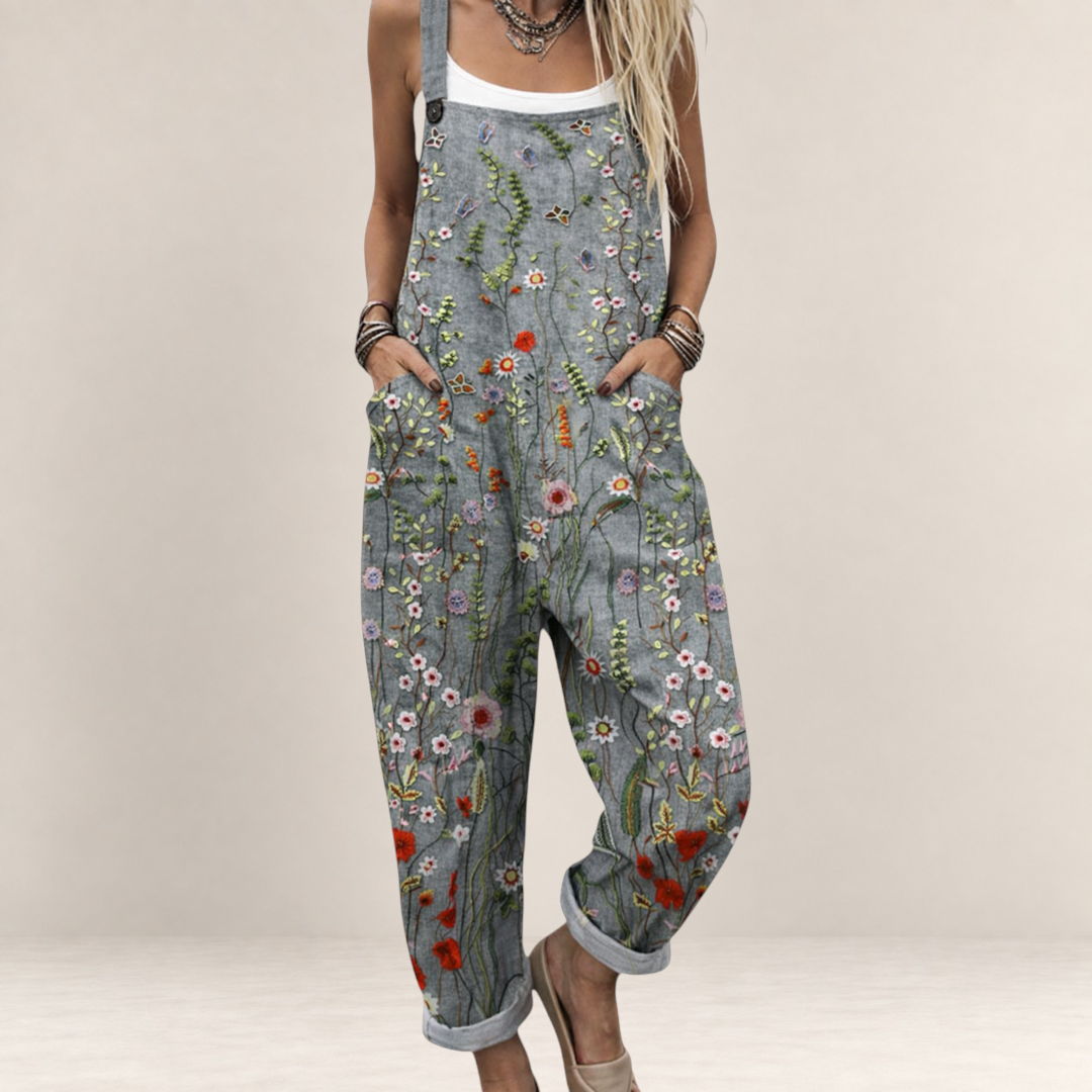 Valvet Oak House grey floral print loose-fit jumpsuit with wide legs and adjustable straps on a woman