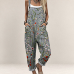 Valvet Oak House grey floral print loose-fit jumpsuit with wide legs and adjustable straps on a woman