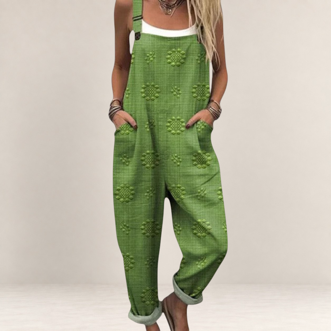 Valvet Oak House green printed wide-leg jumpsuit with adjustable straps and side pockets worn over a white top