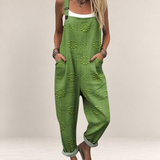 Valvet Oak House green printed wide-leg jumpsuit with adjustable straps and side pockets worn over a white top