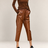 Valvet Oak House brown faux leather trousers with a loose fit, elastic waistband, and side pockets on a model