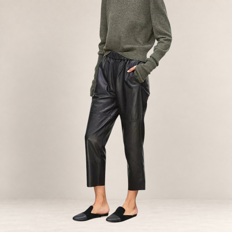 Valvet Oak House black faux leather trousers with a loose fit, elastic waistband, and cropped length on a model.